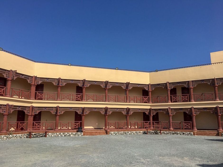 A brown coloured hotel building in the photo