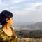 A girl looking towards the mountains in the background