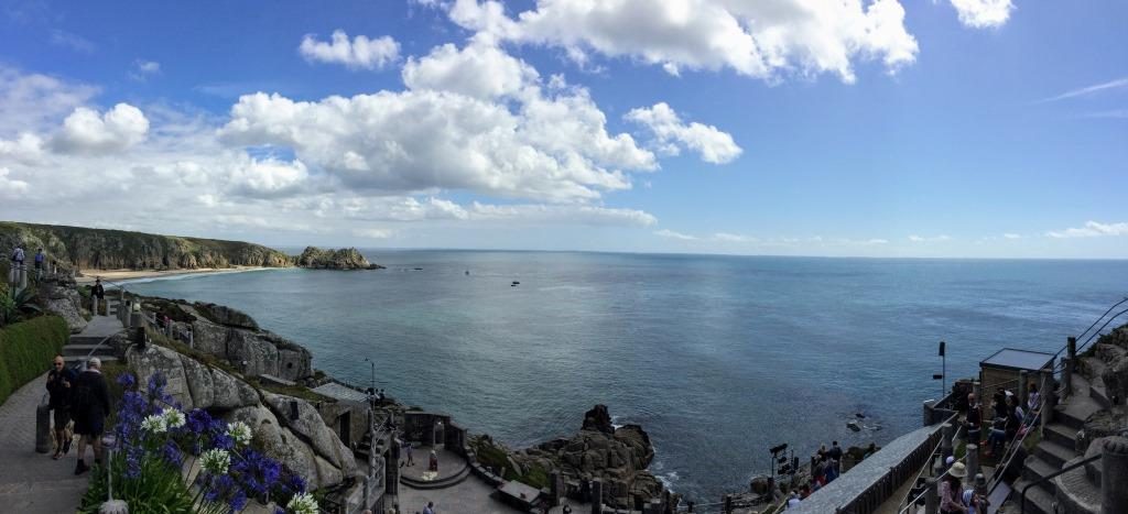 Blue sea viewed against granite rocks as seen from the top of Minack Theatre in Cornwall
