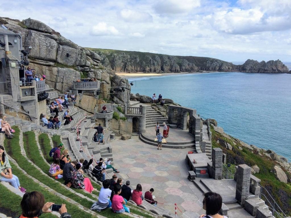 Seating area of Minack Theatre with people sitting 